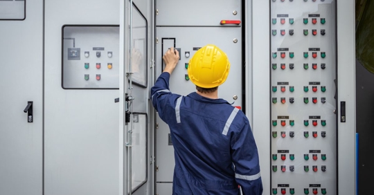 man looking at commercial electrical system
